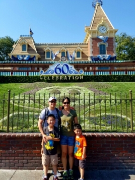 Family pic by the entrance to Disneyland.